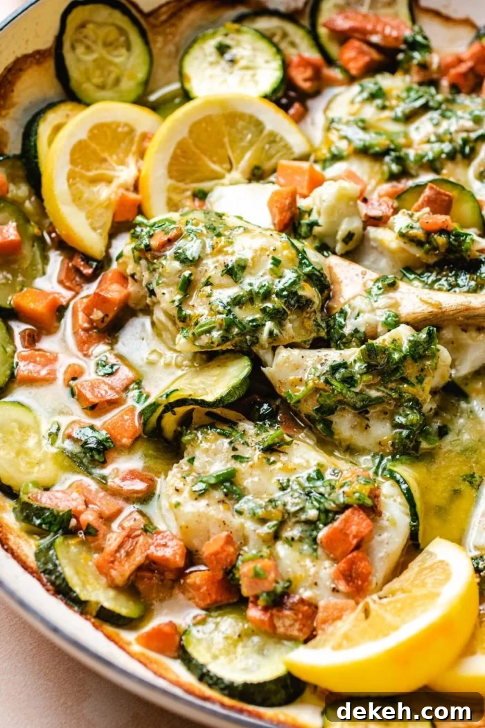 photo shows baked cod fillets covered with herb butter on top and melted in the pan