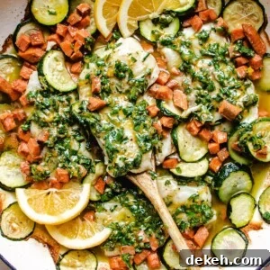 Cod fish baked with vegetables and lemon herb butter sauce in one big white casserole skillet