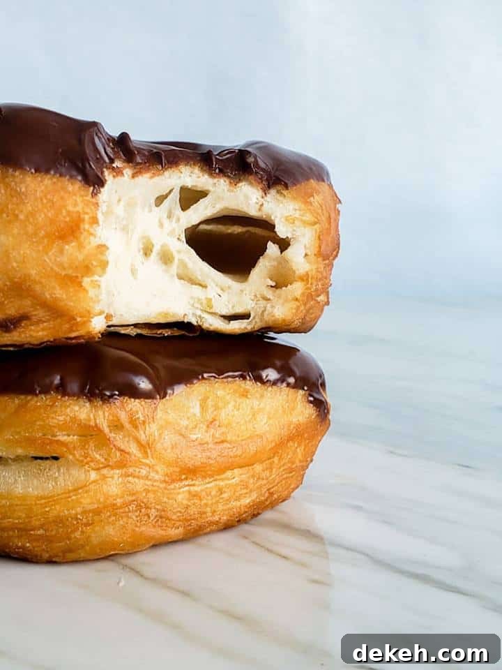 Shot of stack of donut with bit out of one.