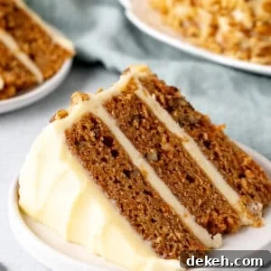 Slice of carrot cake layer cake with cream cheese icing