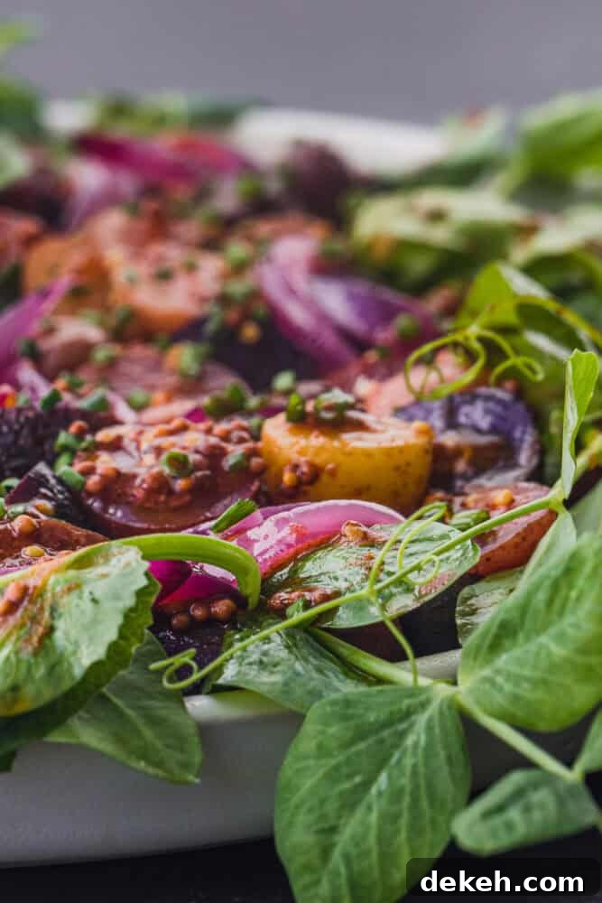 close up of no mayo potato salad with baby potatoes, shallots and watercress