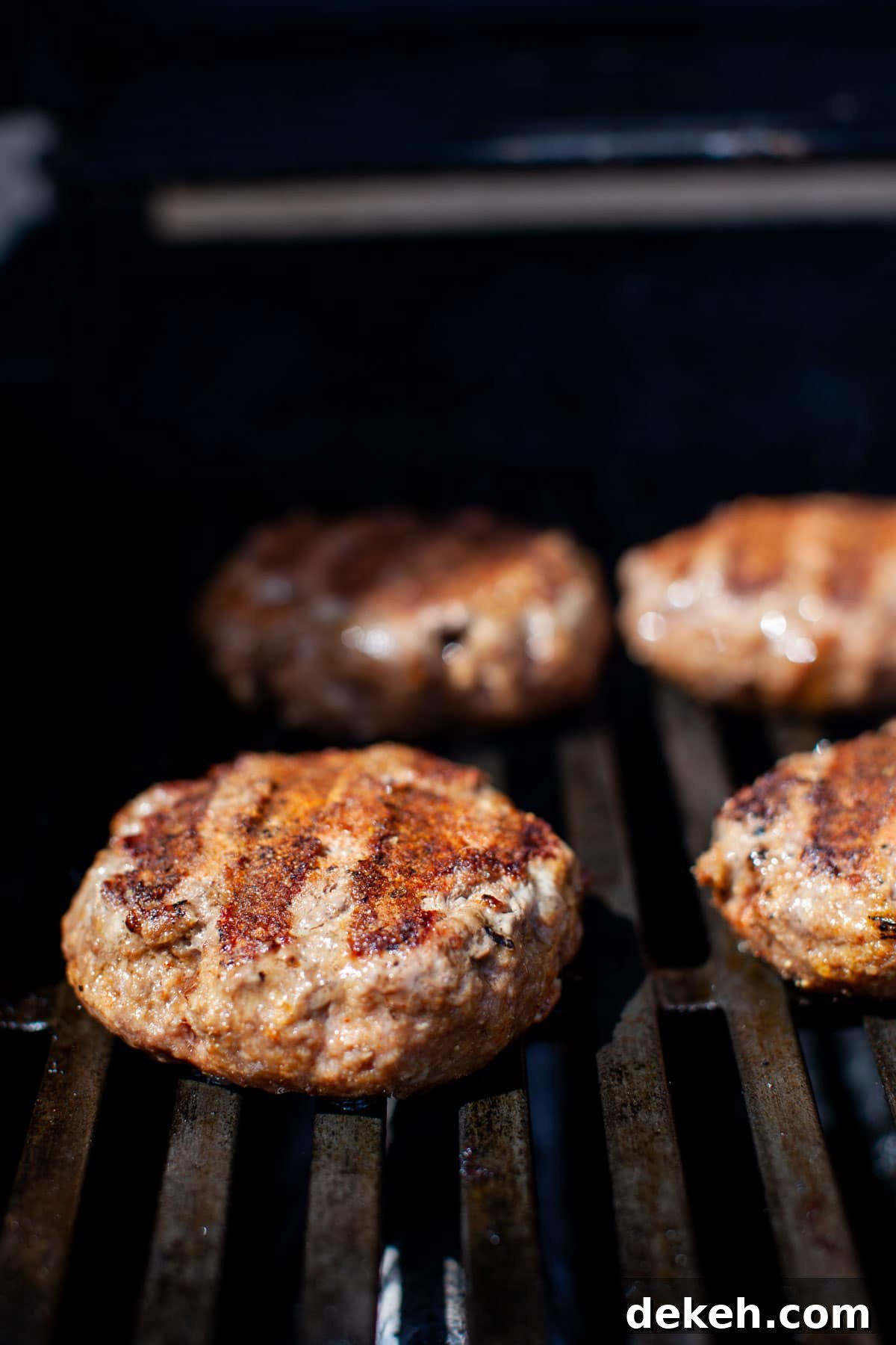Beef burgers on the grill.