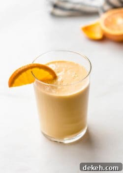an orange creamsicle smoothie with an orange slice in it