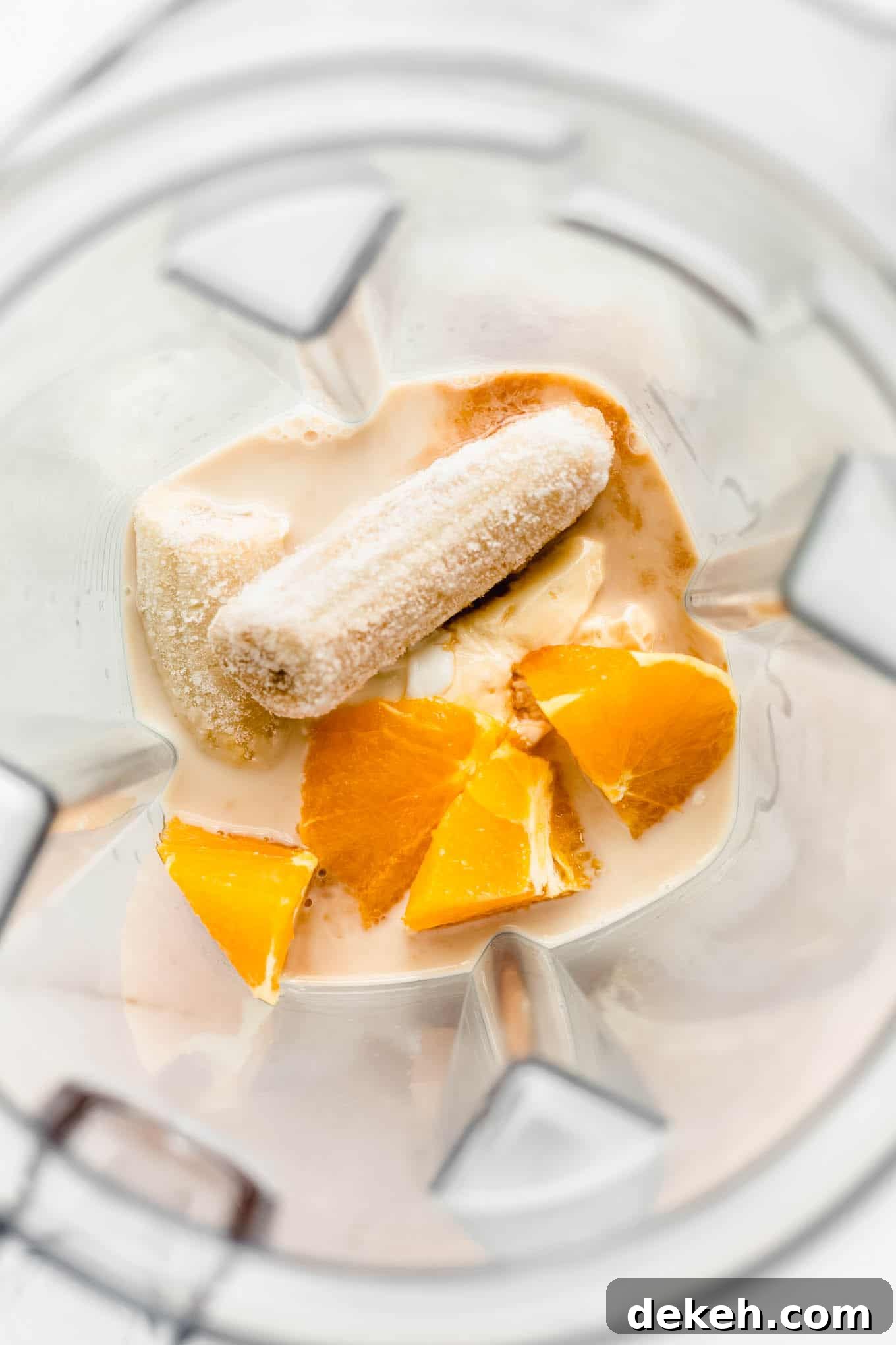 banana, oranges, and almond milk in a blender
