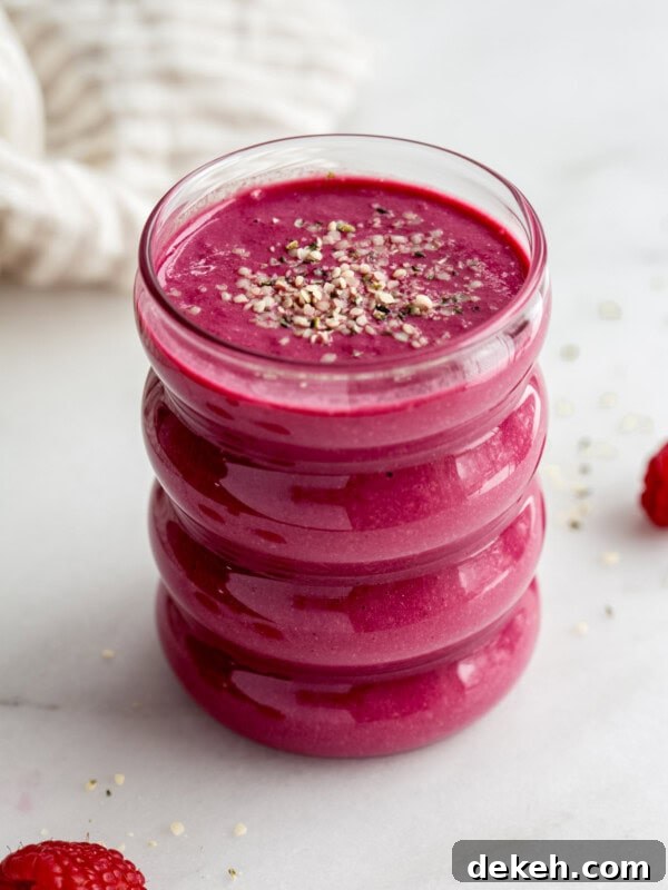 a glass of beet smoothie with a napkin in the background