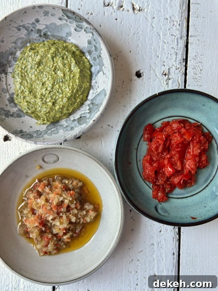 pesto in a bowl, peppadew peppers in a bowl, giardiniare in a bowl on a white counter