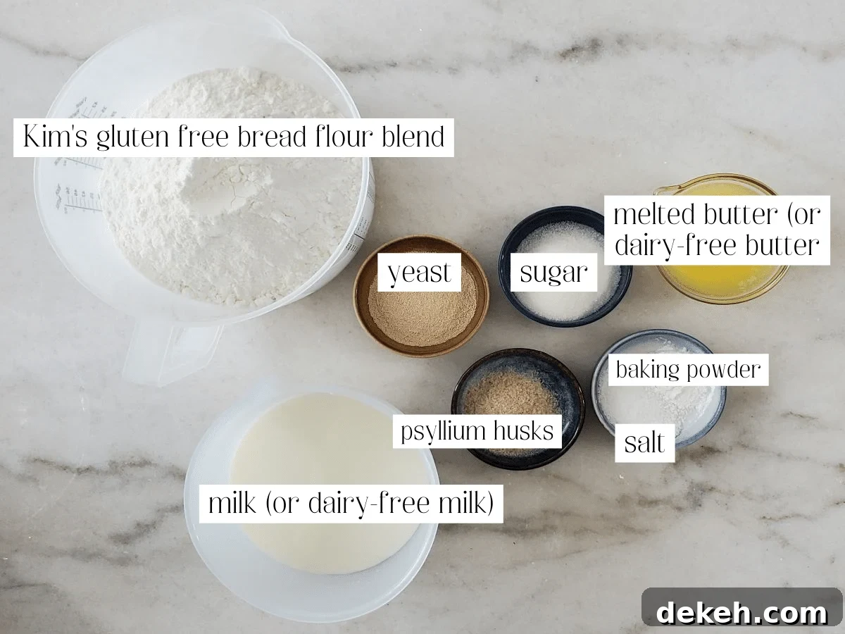 ingredients for sandwich bread measured out and labeled on marble countertop.