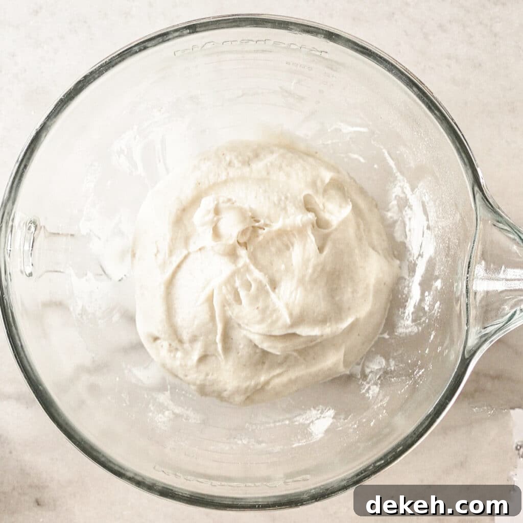 scraping dough together into center of glass bowl.