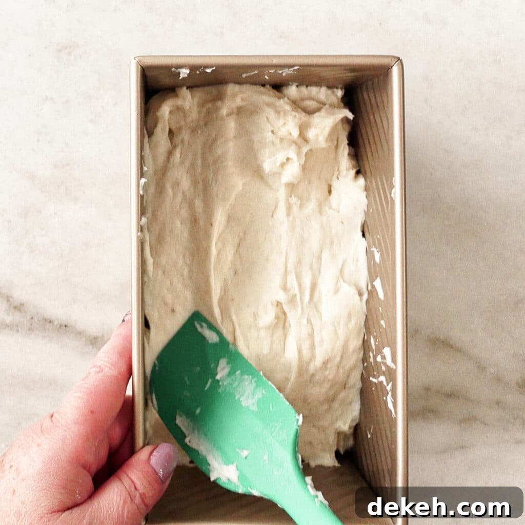 spreading dough into loaf pan.