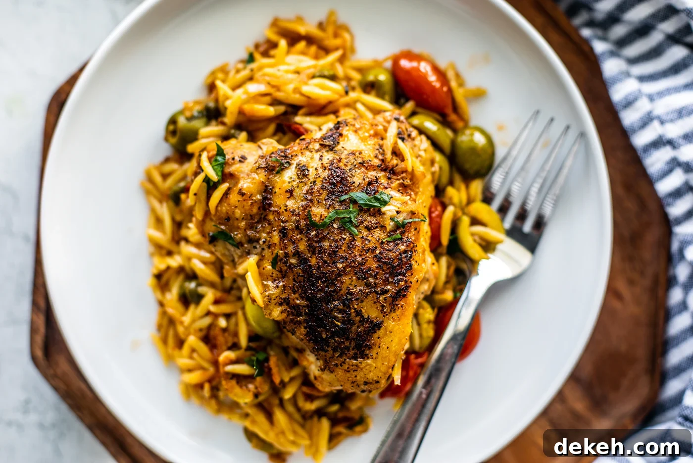 Overhead shot of plateful of orzo with crispy chicken on top.