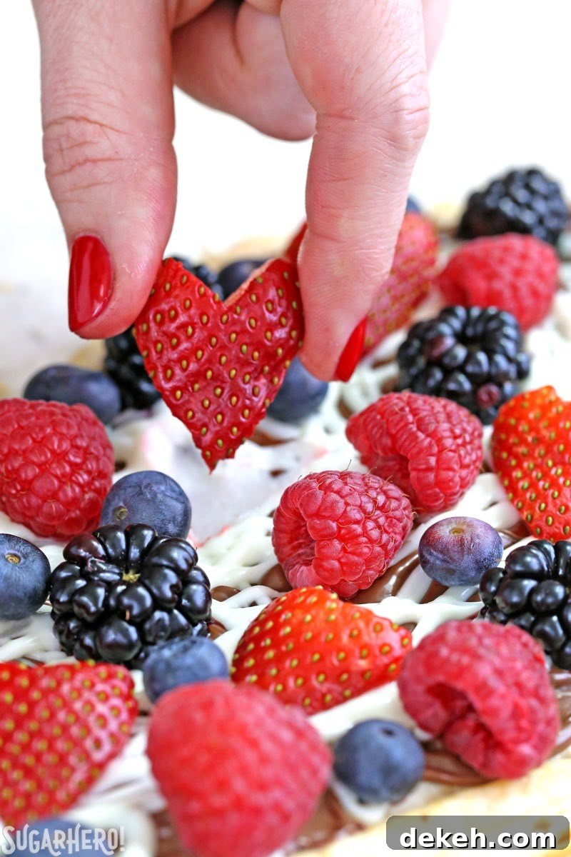 Nutella Puff Pastry Pizza topped with fresh berries and white chocolate drizzle.