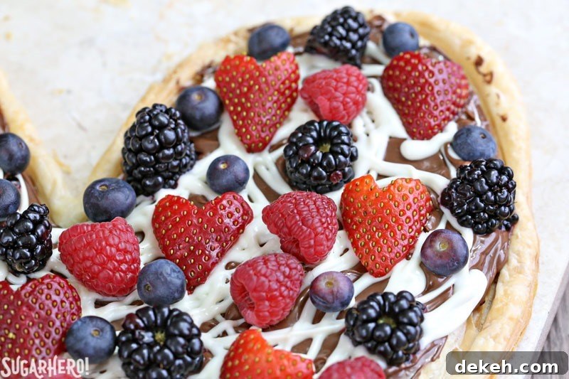 Mini Nutella Puff Pastry Pizza pieces topped with berries.