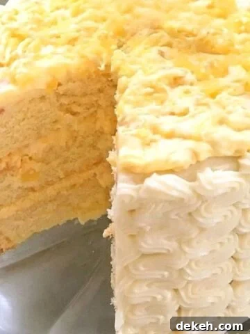 Moist Pineapple Cake, sliced, on a cake plate.