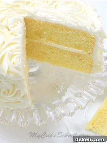 Lemon Cake from Scratch, sliced, on a cake pedestal.