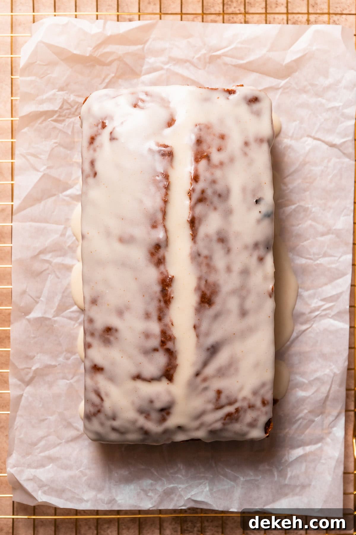 The glazed brown butter banana bread loaf on parchment paper.