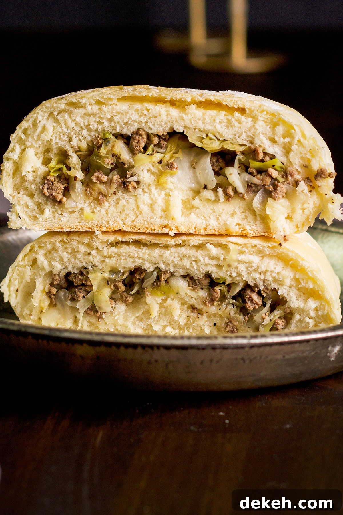 A krautburger that's been made with homemade white bread dough and cut in half.