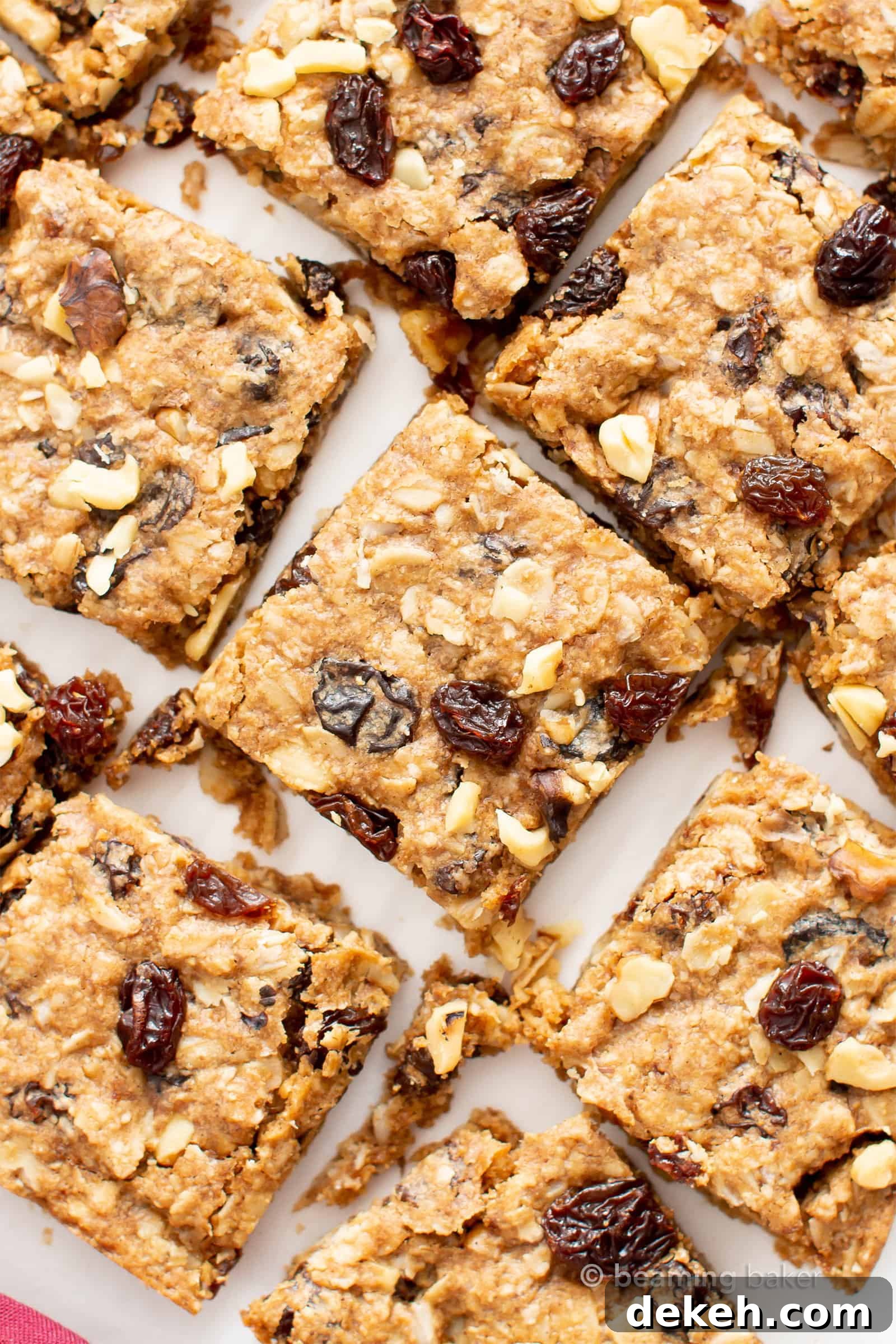 The BEST Vegan Oatmeal Raisin Bars Recipe: chewy centers, crispy edges, packed with raisins & oats! The ultimate gluten free oatmeal cookie bars—healthy, homemade & easy! #Oatmeal #Vegan #GlutenFree #Cookies | Recipe at BeamingBaker.com