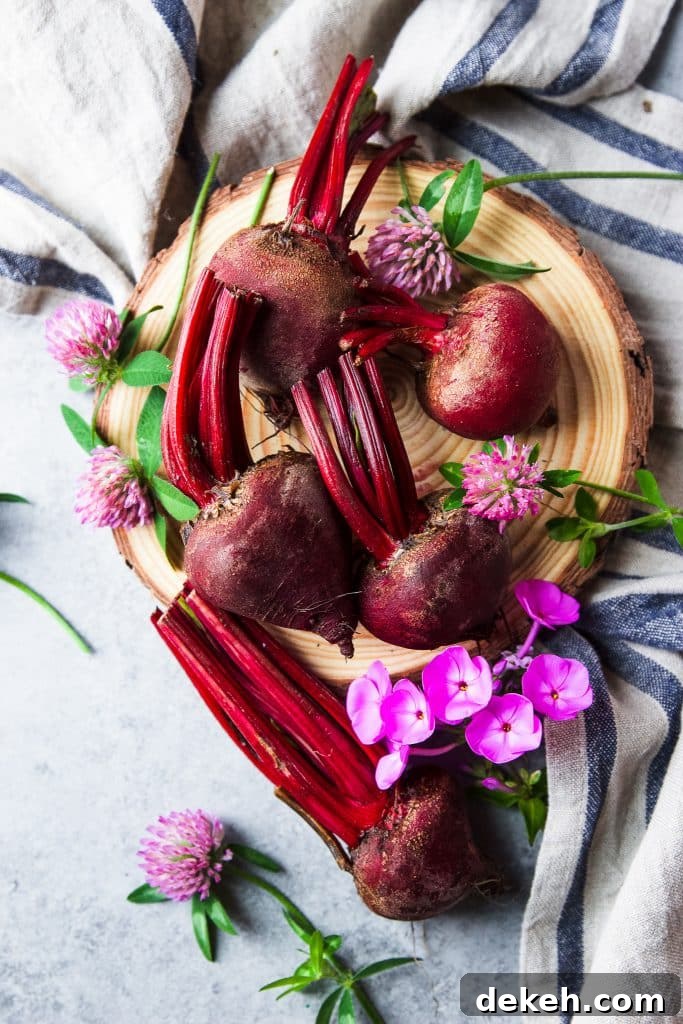 Fresh beets and fresh purple flowers. A rustic tablecloth.