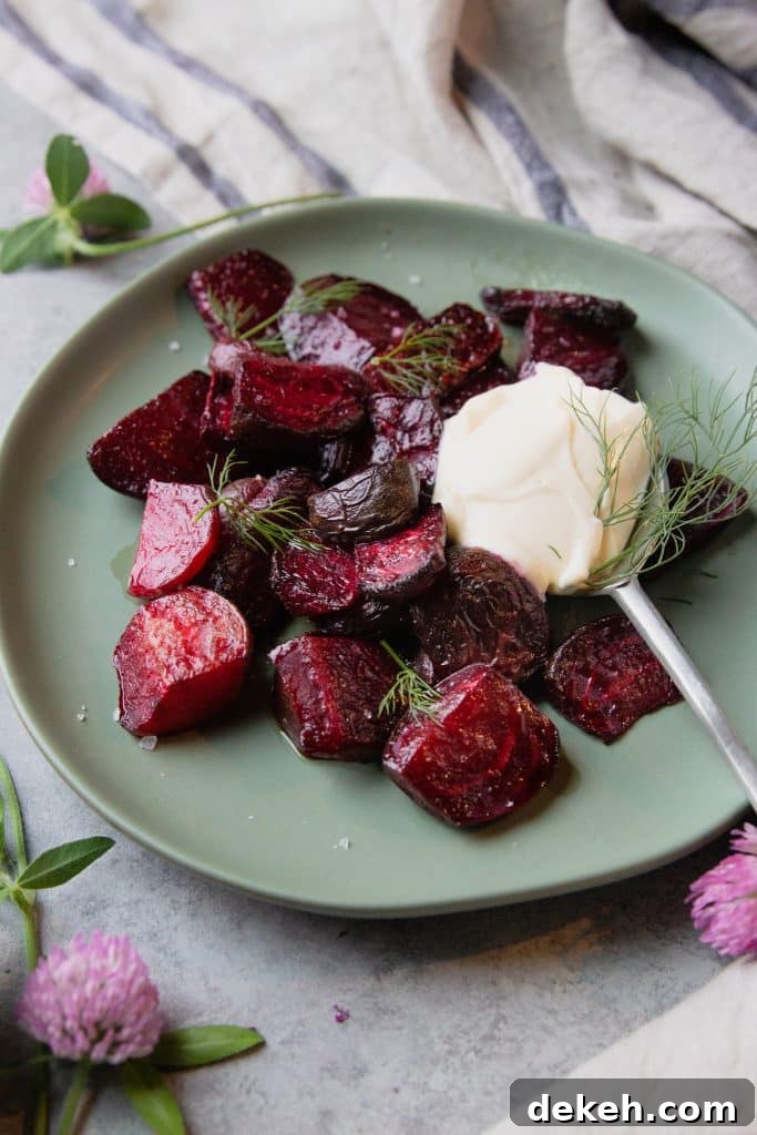 roasted beets on a plate, topped with yogurt and fresh dill