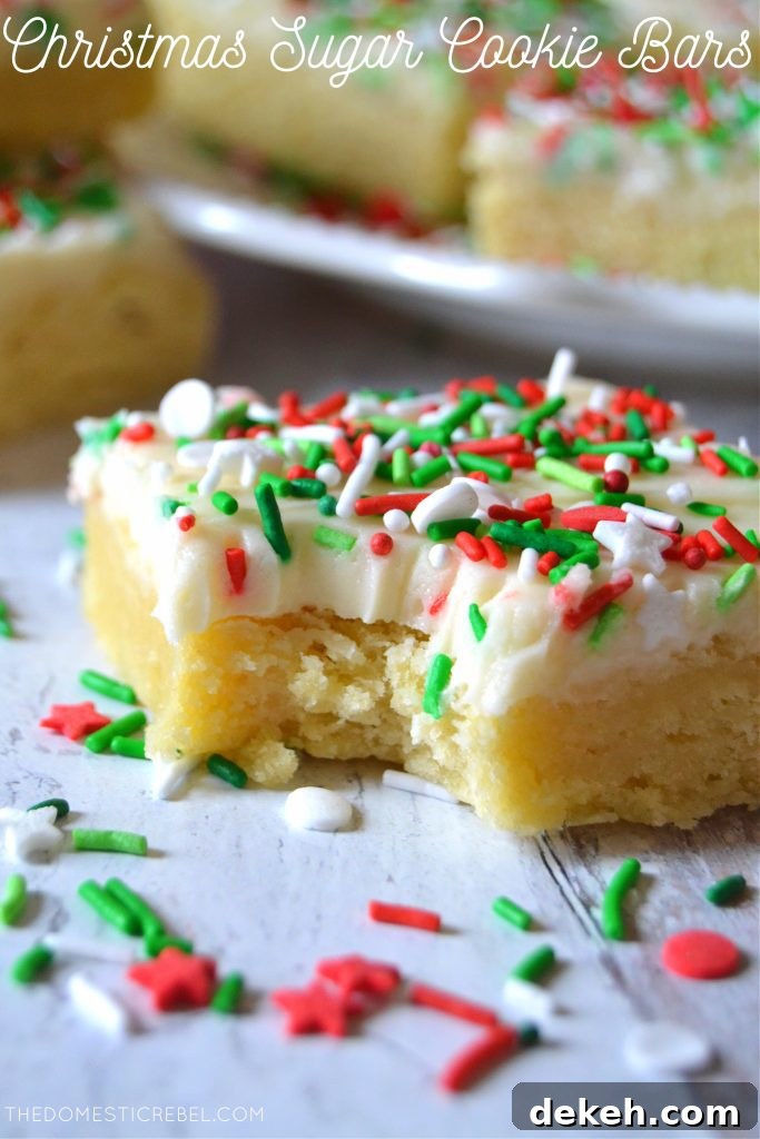 Photo of a bitten Christmas Sugar Cookie Bar surrounded by sprinkles