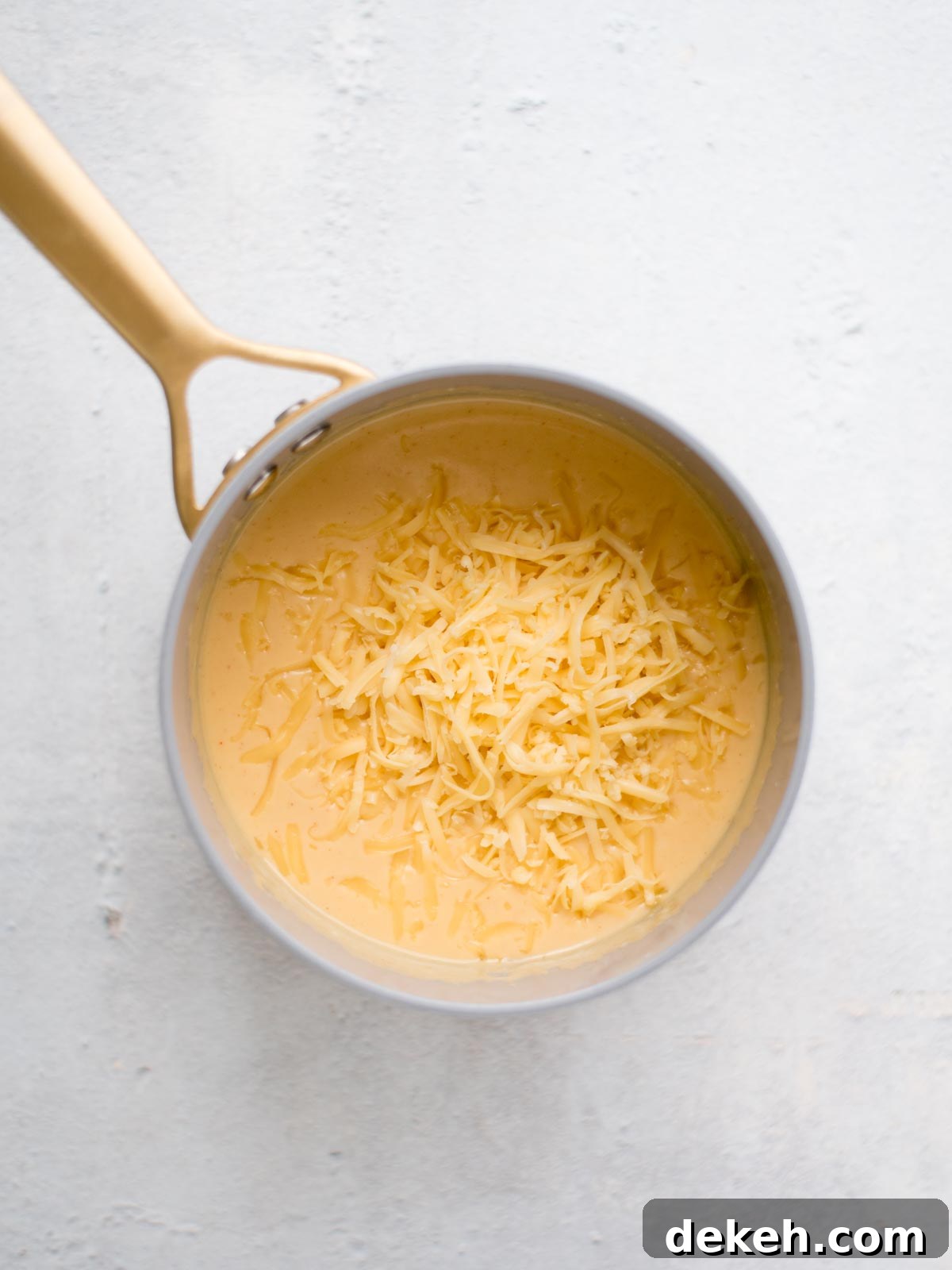 shredded gouda added to the saucepan