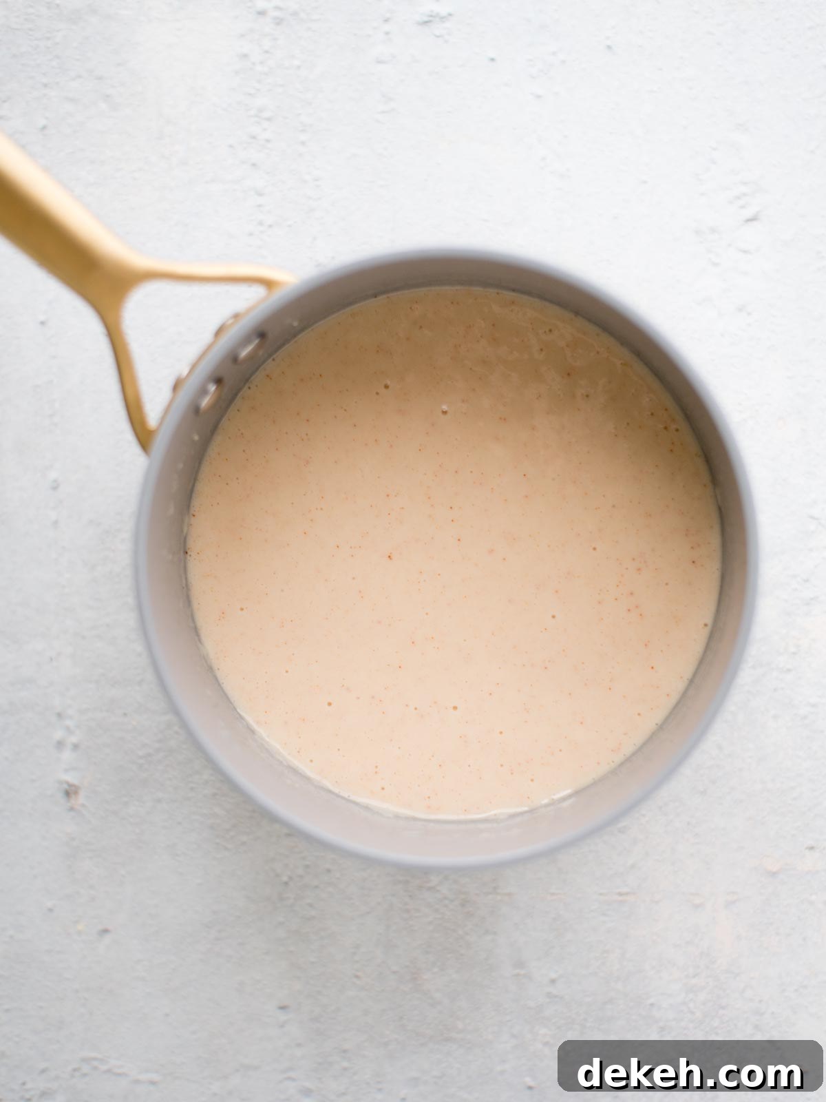 seasoned milk and roux in a saucepan