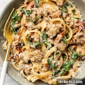 a bowl of Tuscan sausage pasta with a fork