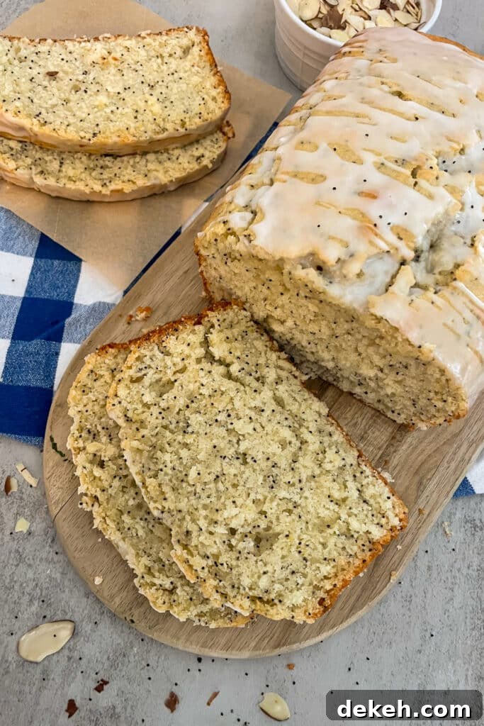 almond poppyseed bread on a cutting board.  Slices of bread for serving. 