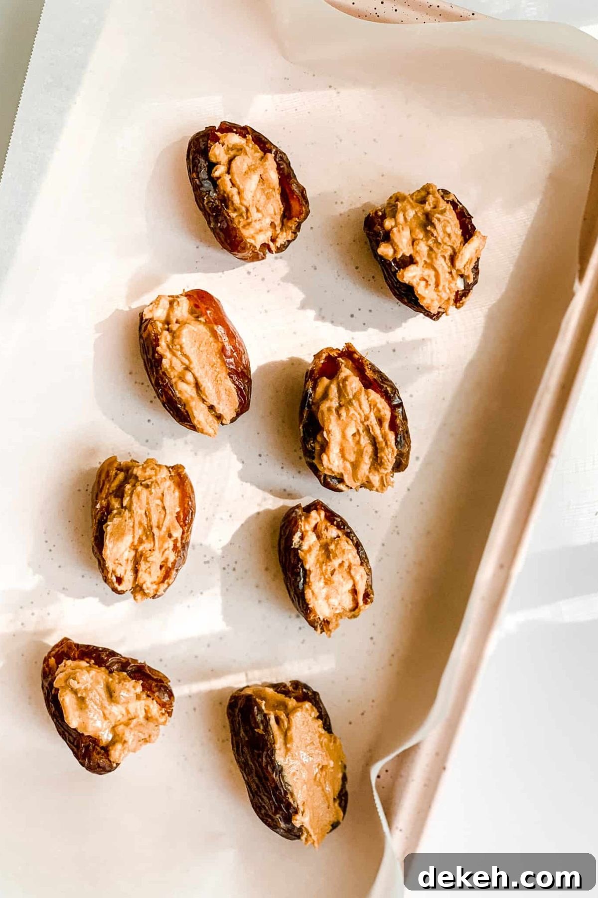 Pink Baking Sheet with Healthy Salted Chocolate Date Candies with Nut Butter