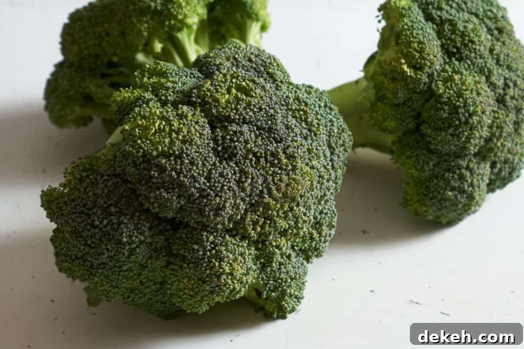Three fresh broccoli crowns.