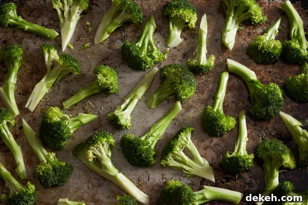 Sliced broccoli florets on a sheet pan.
