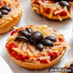 Completed Mini Spider Pizza [Bagel Bites] on a white surface.