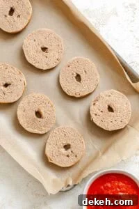 Process shot showing bagels on a baking tray.