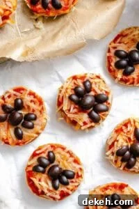 Completed Mini Spider Pizza [Bagel Bites] on a white surface.