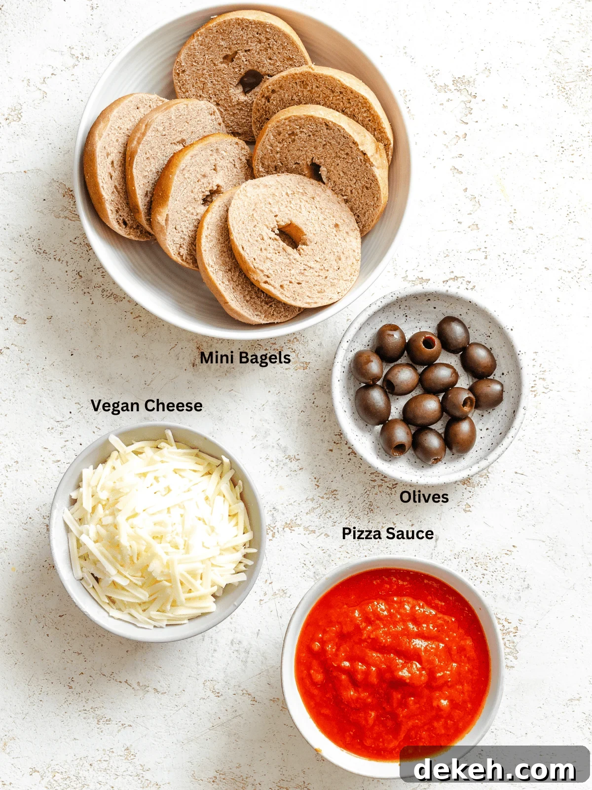 Ingredients for Mini Spider Pizza [Bagel Bites] measured out on a white surface.