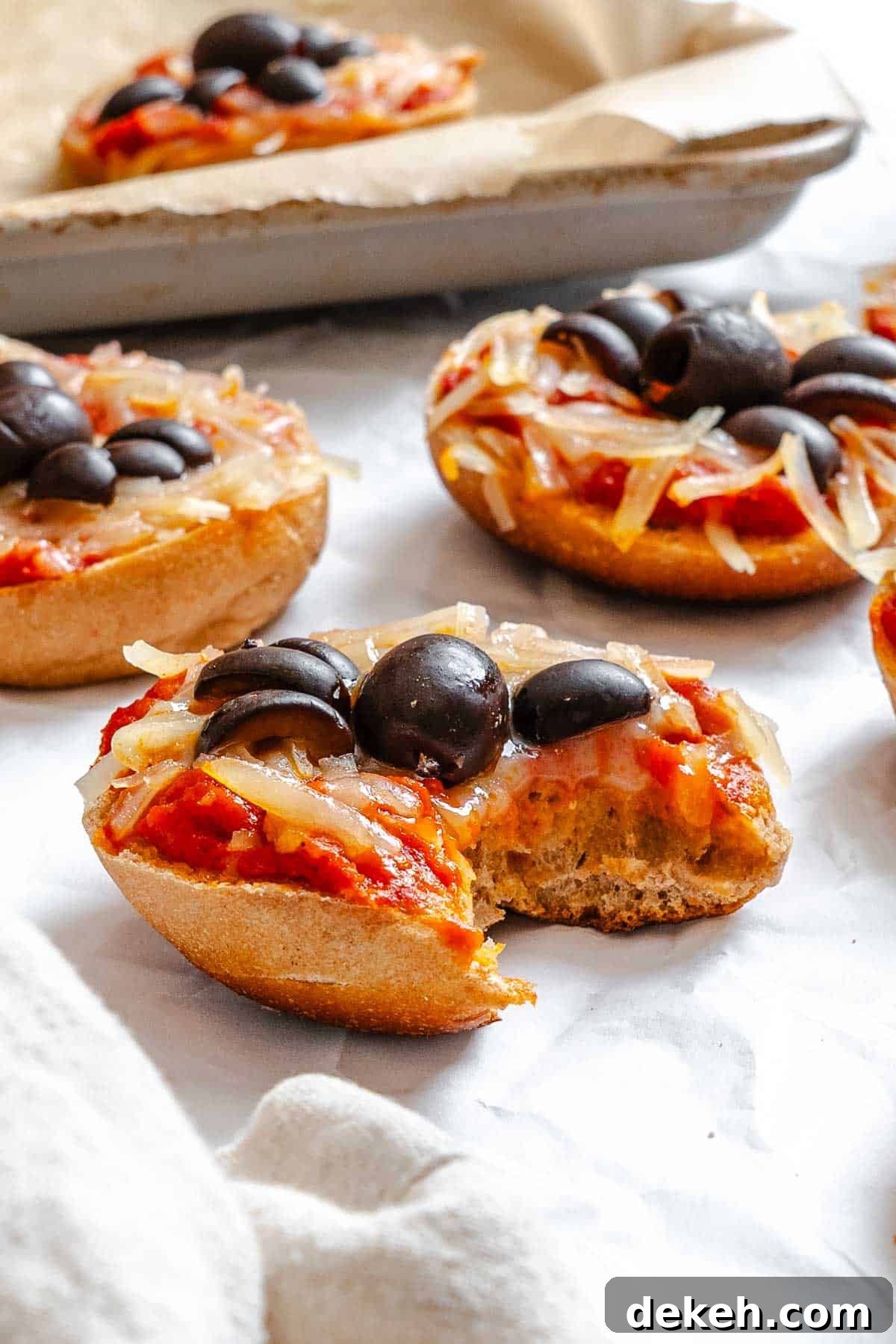 Completed Mini Spider Pizza [Bagel Bites] on a white surface.