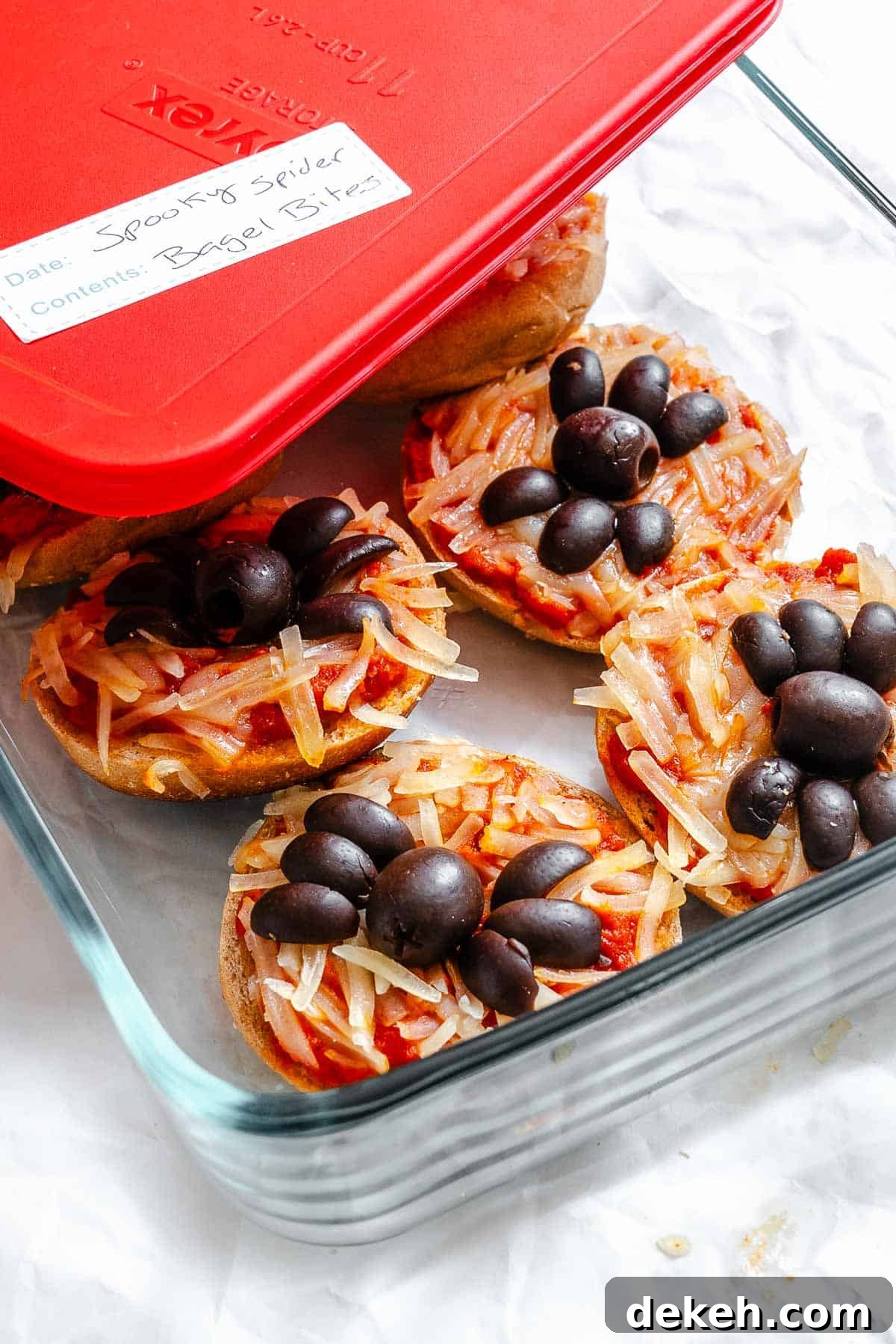 Completed Mini Spider Pizza [Bagel Bites] in a storage container.
