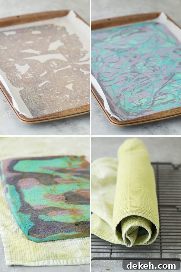 Multi-colored galaxy cake roll with black chocolate ganache, topped with sprinkles!