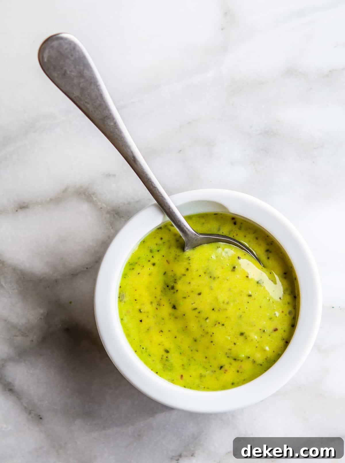 Pesto Aioli served in a white bowl with a spoon