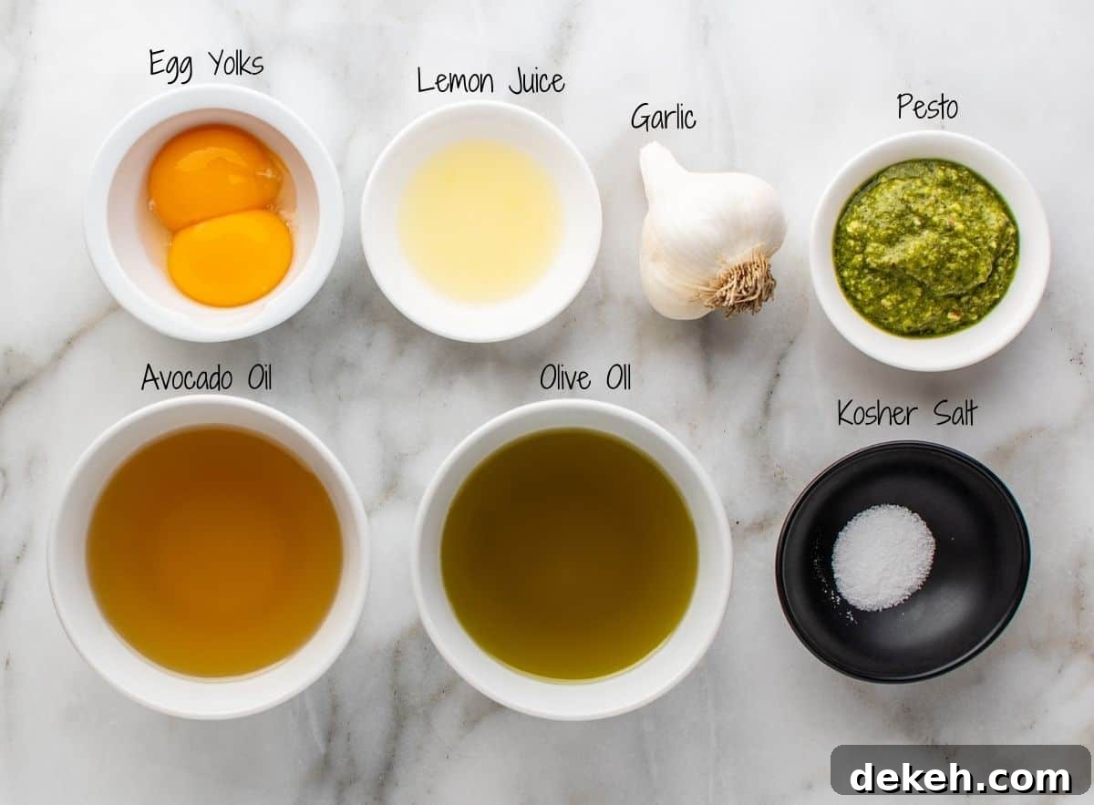 Pesto Aioli Recipe: Creamy Basil Garlic Sauce for Sandwiches & Dips 3 Pesto Aioli Ingredients on a white marble board.