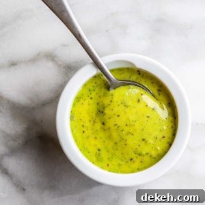 Pesto Aioli Recipe: Creamy Basil Garlic Sauce for Sandwiches & Dips 4 Pesto Aioli in a white bowl with a spoon in it