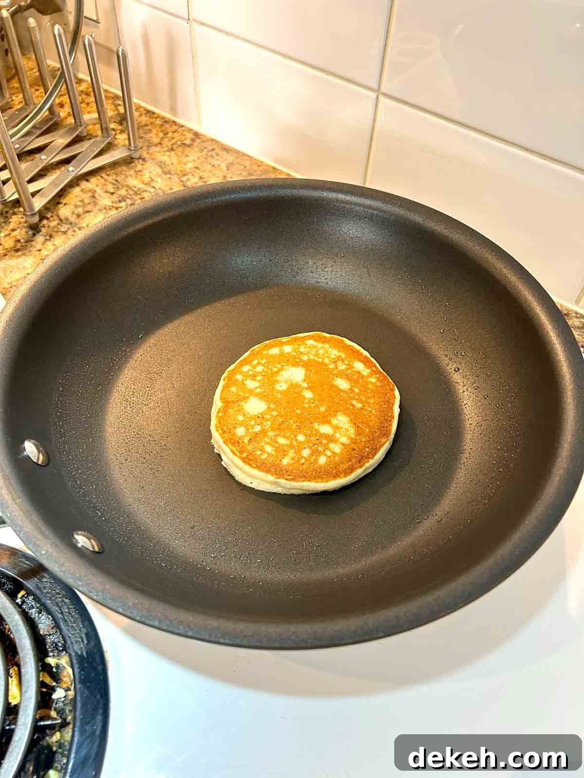second side of pancake being cooked; golden brown on top.
