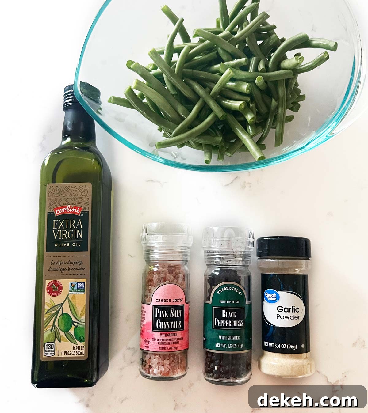 Baked Green Beans Ingredients green beans, olive oil, salt, pepper and garlic powder on a kitchen counter.