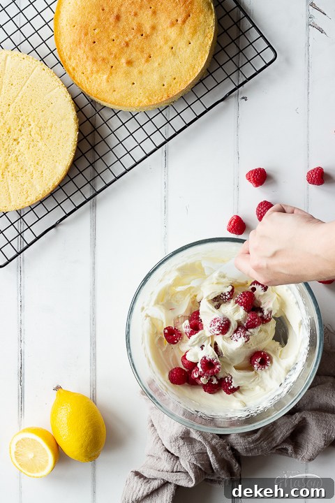 Raspberries being folded into sweetened cream.