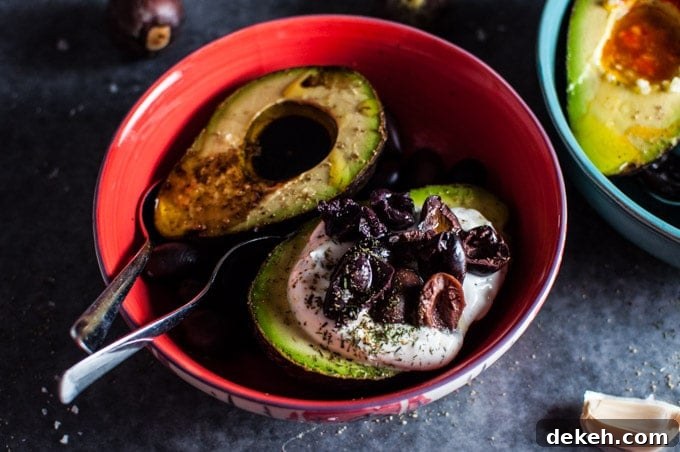 red bowl with two avocado halves