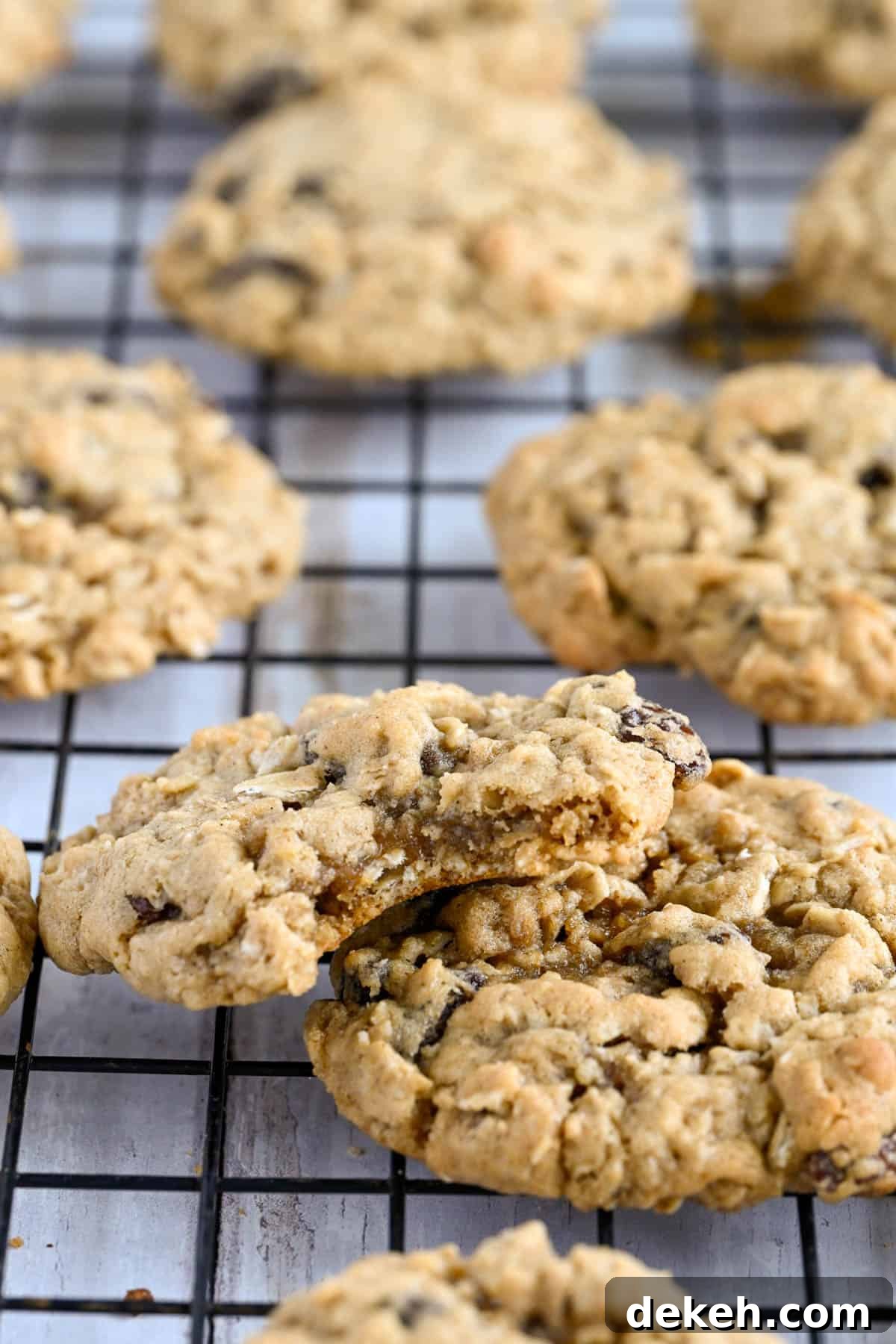 Soft baked chewy oatmeal cookies on a wire rack.
