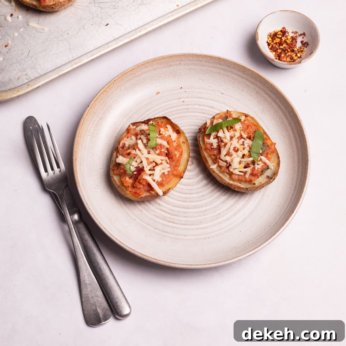 loaded potato skins with fresh basil leaves.