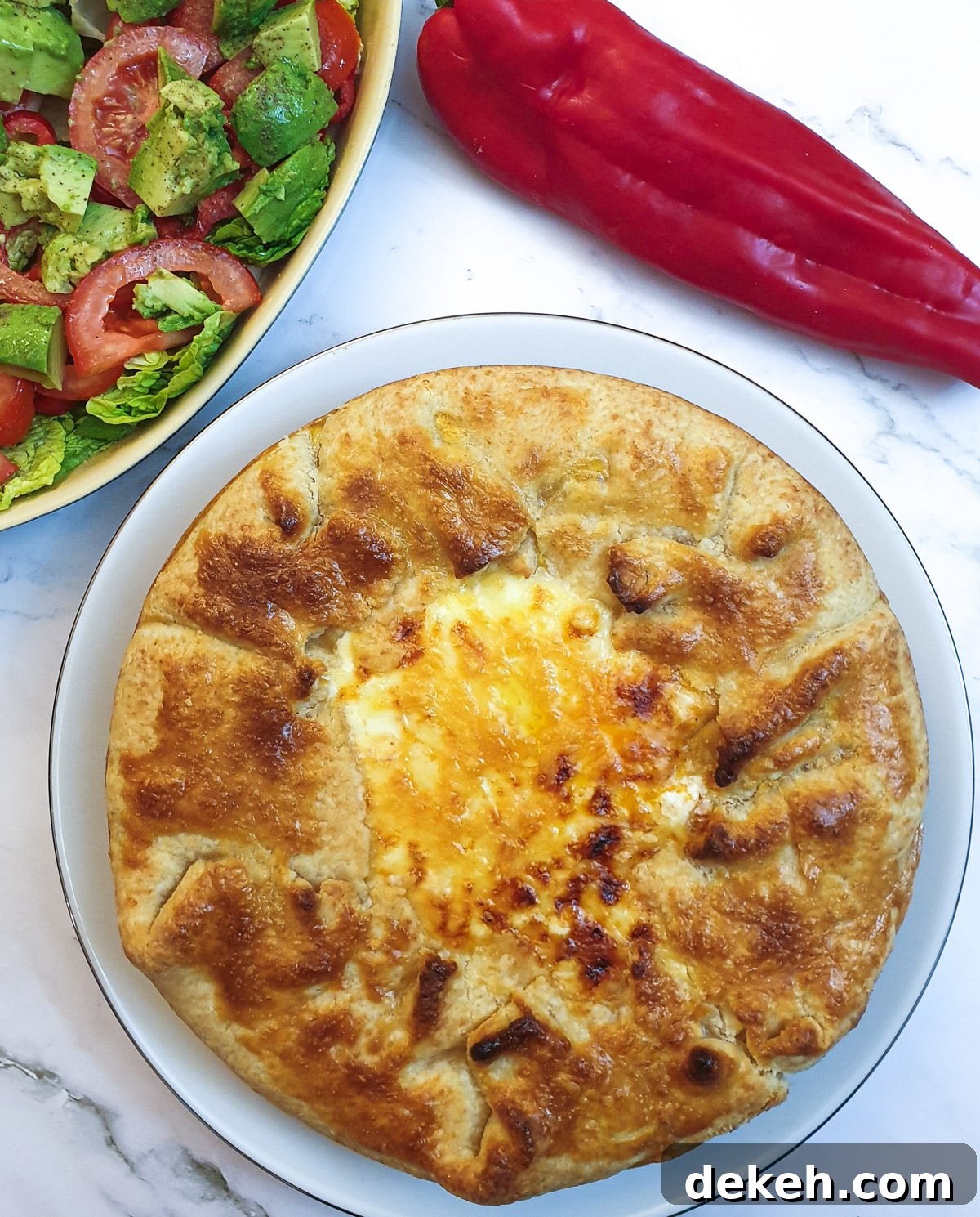 A Tex Mex beef pie showing the crispy pastry around the edge and the golden melted cheese in the middle.