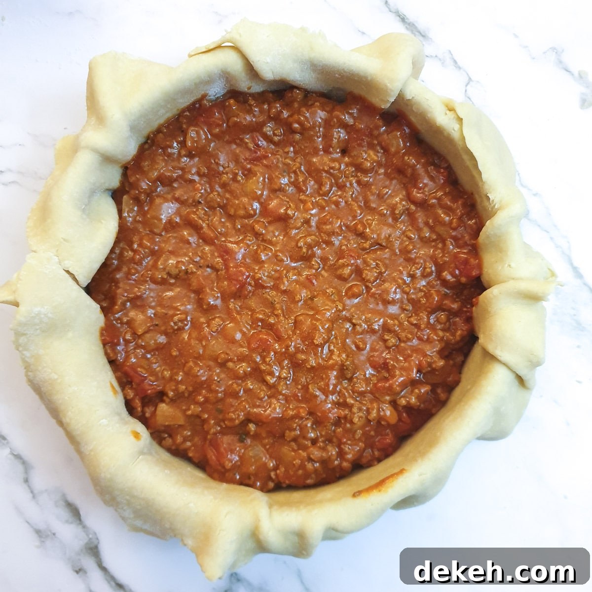The pie filling in the pastry case.