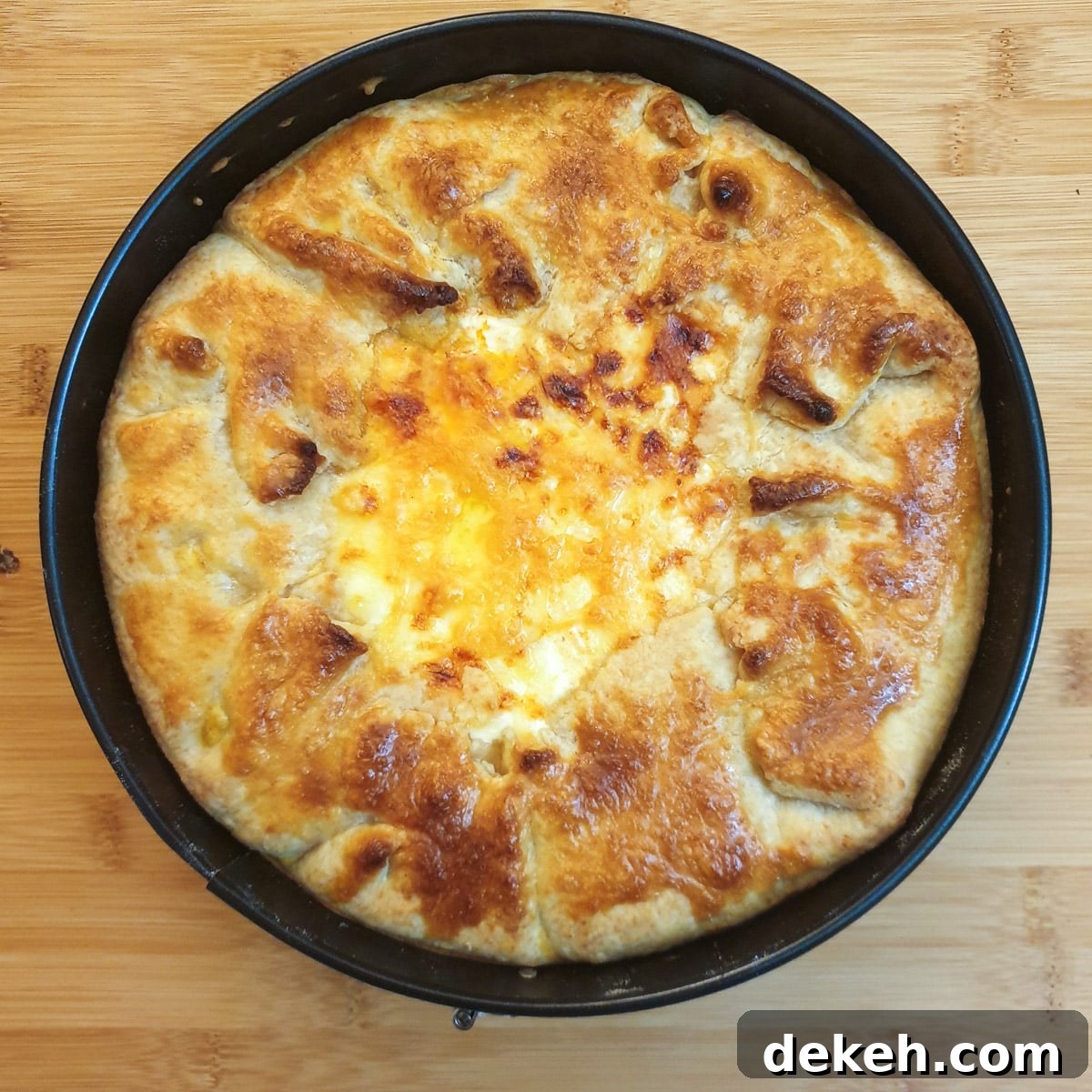 A baked Tex Mex beef pie showing the crispy pastry around the edge and the golden melted cheese in the middle.